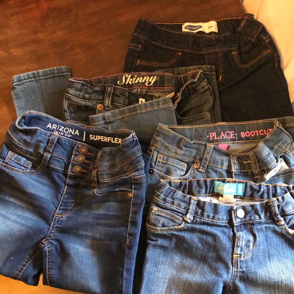 5 pairs of new 5t/5. girls jeans. NWOT. Variety of styles adjustable waist.